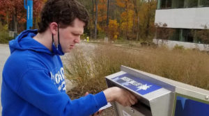 A man putting a letter in the mailbox.