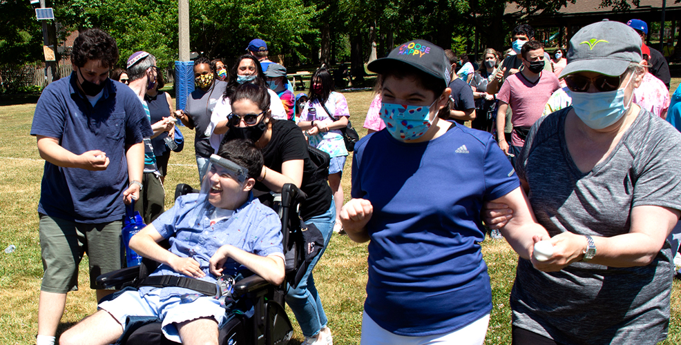 Participants, one walking and one using a wheel chair, as part of a race for a special GADOL event.