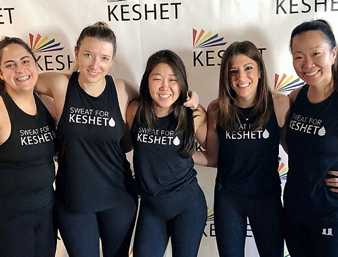 Four women wearing Sweat for Kehet tank tops before participating in the Junior Board cycling event.