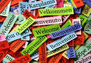Little slips of colorful paper that say welcome in different languages