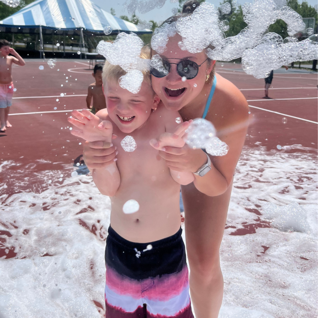 Sara playing in the foam party with her camper