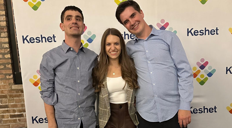 Victoria with her brothers Ethan and Adam in front of the Keshet step and repeat