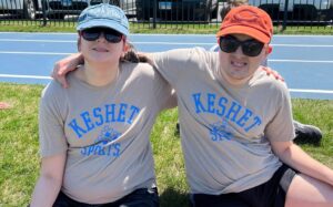 Rachel and Adam in matching Keshet t-shirts with their arms around one another