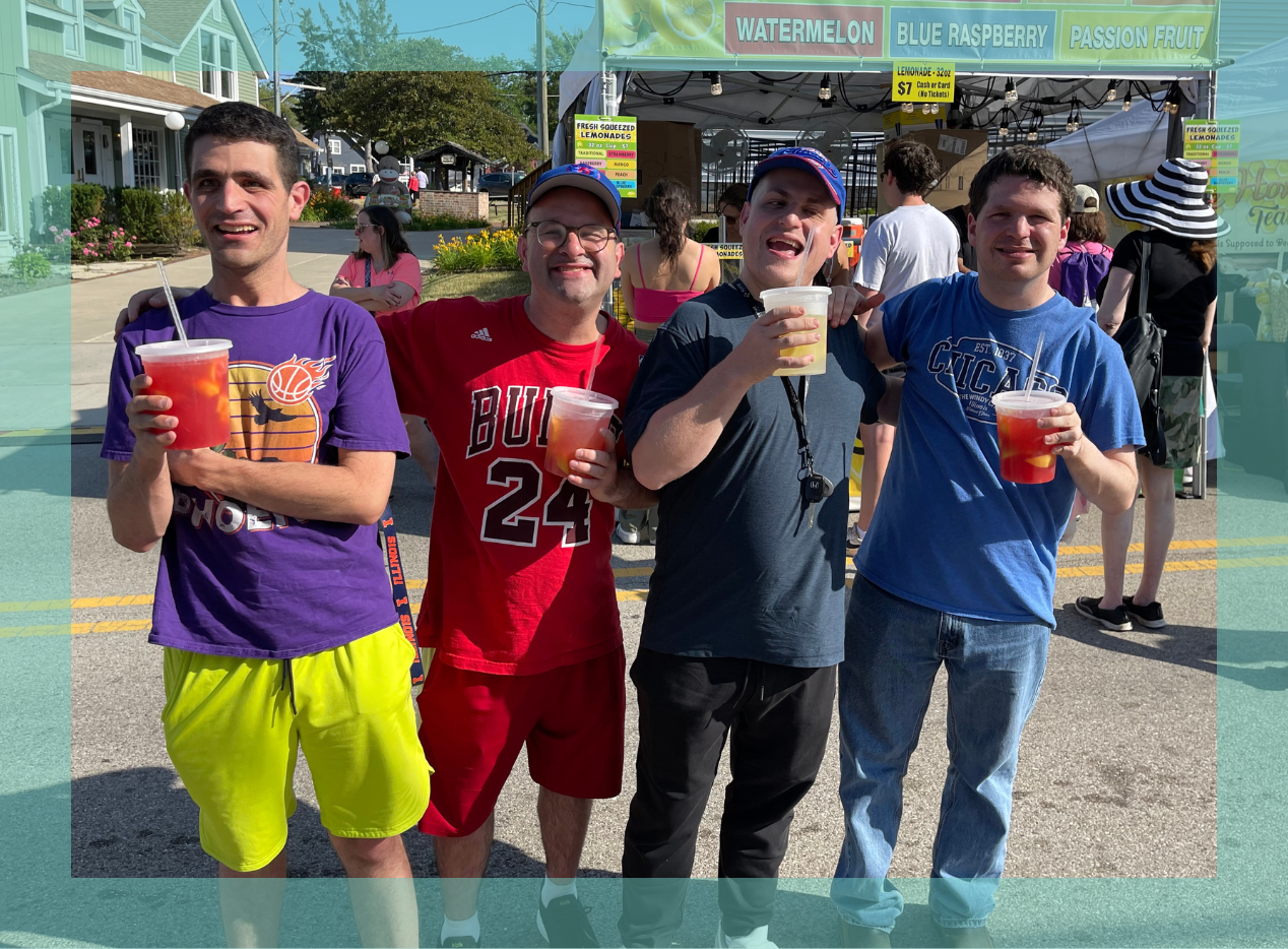 Four adult males holding lemonade and smiling with their arms around each other with a blue border around it