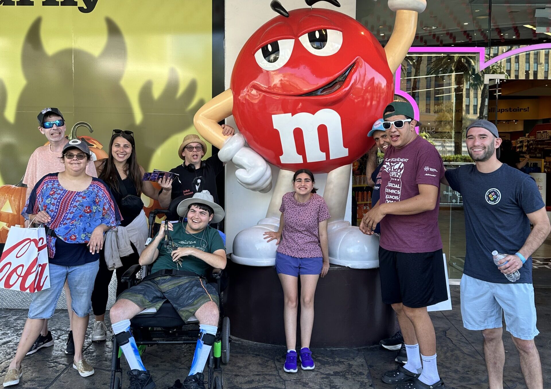 Group of adults standing outside the M&M store