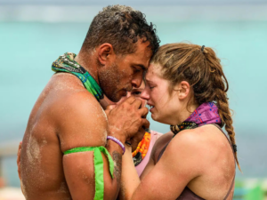 Two survivor players with their faces together and locking hands