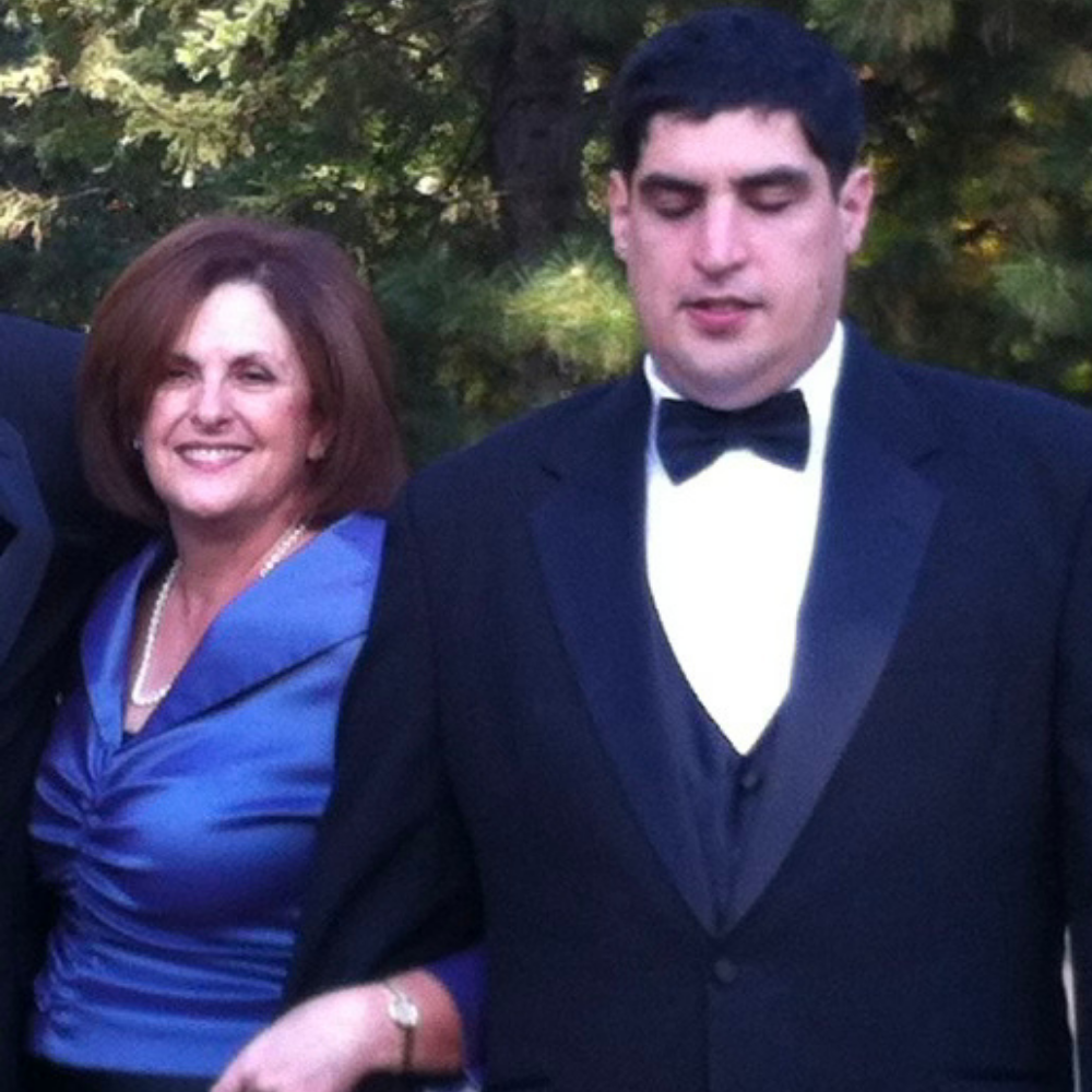 Margaret and her son Mikey standing together in formal clothes