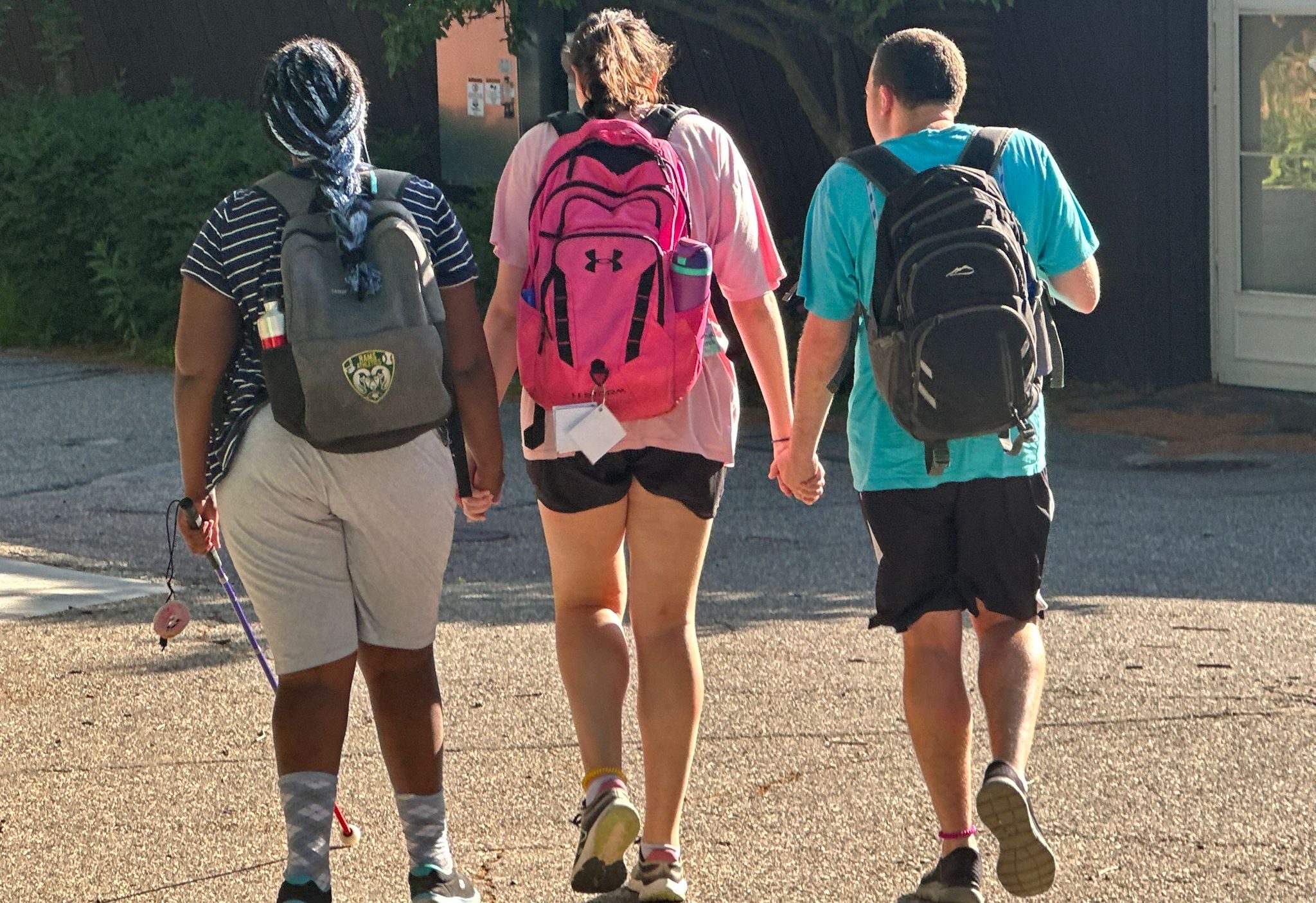 Three campers holding hands