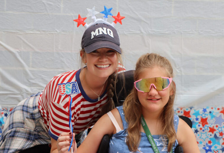 Camper and counselor smiling with USA background