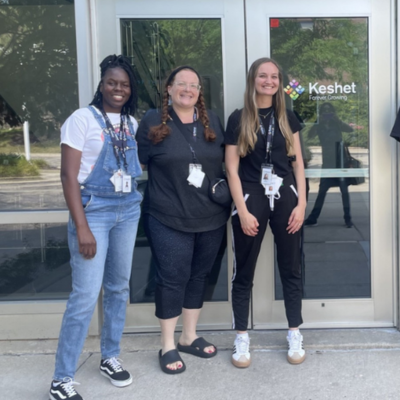 Three staff standing outside the keshet building together