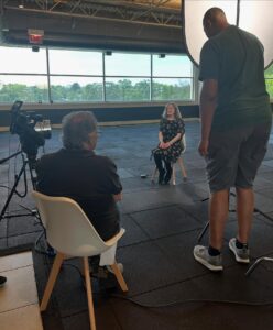Team member being interviewed in the building