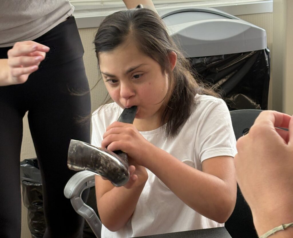 Student blowing the shofar