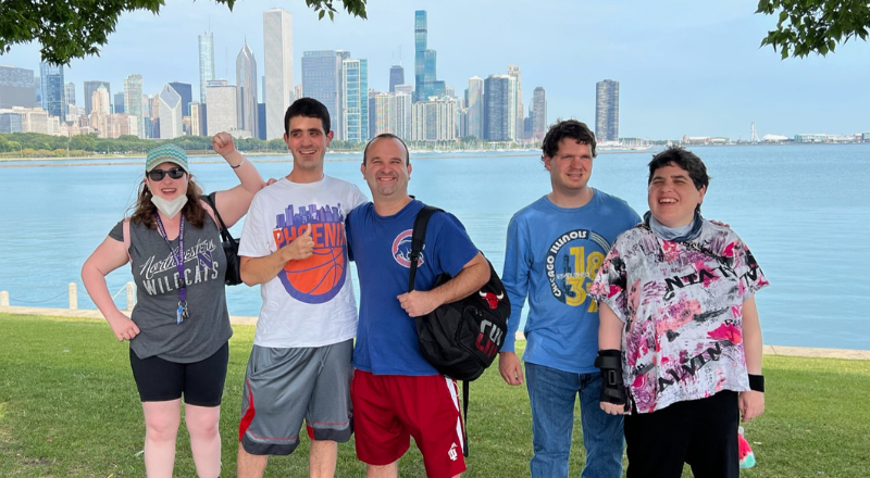 Group of adults standing in front of Lake Michigan and Chicago skyline