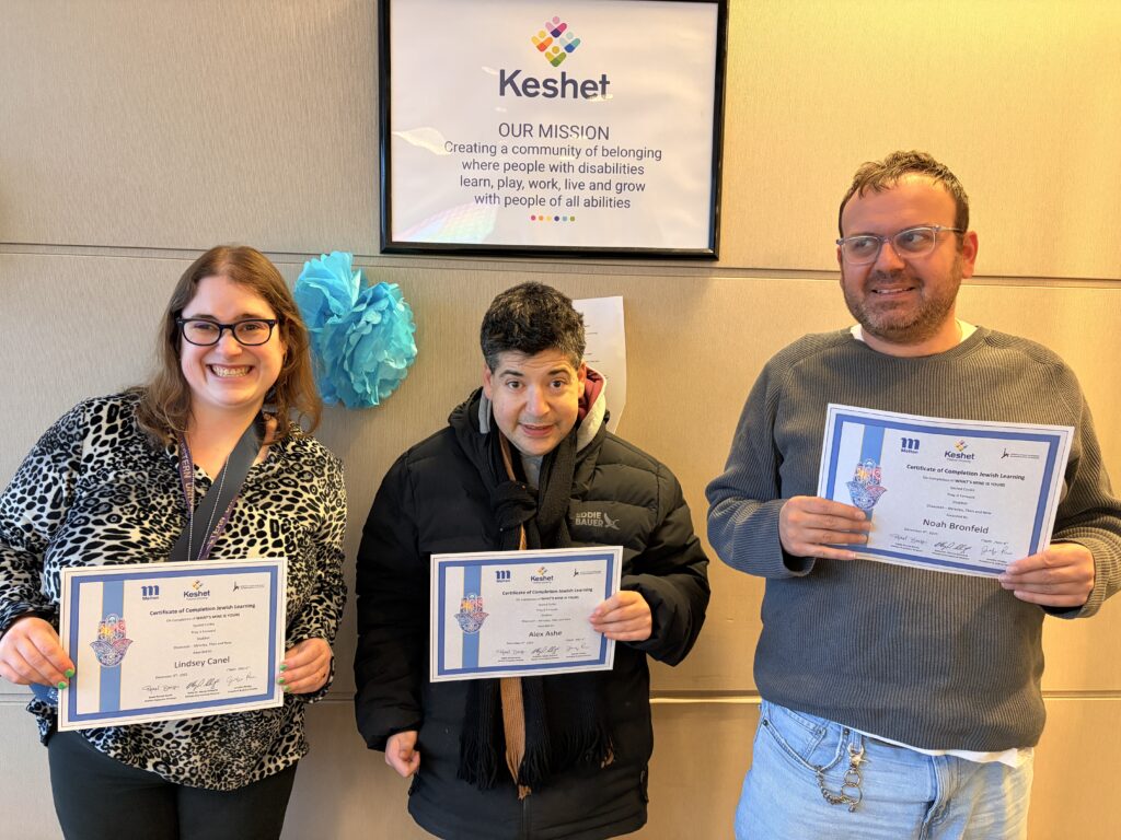 Three adults holding their melton certificates