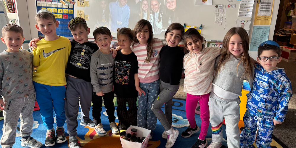 Group of students all standing together with their arms around each other