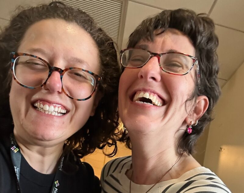 Toby smiling with a team member