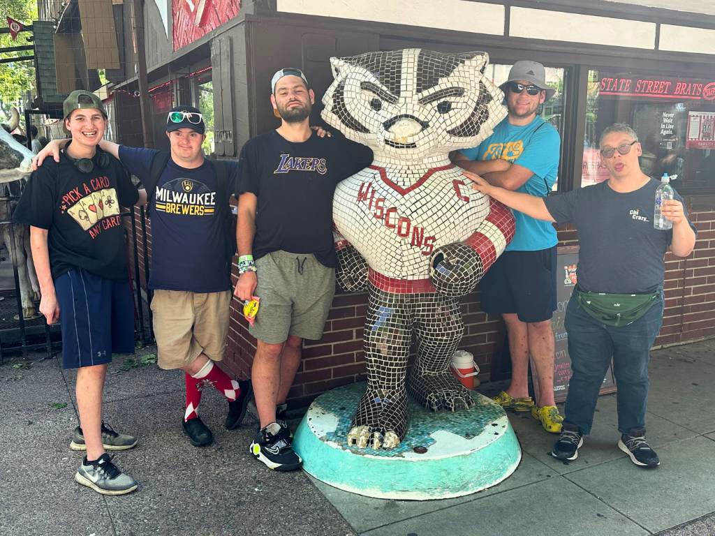 group of adults standing with bucky the badger