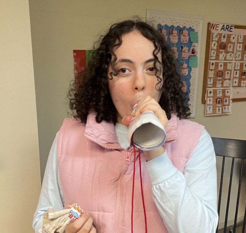 student blowing their paper shofar