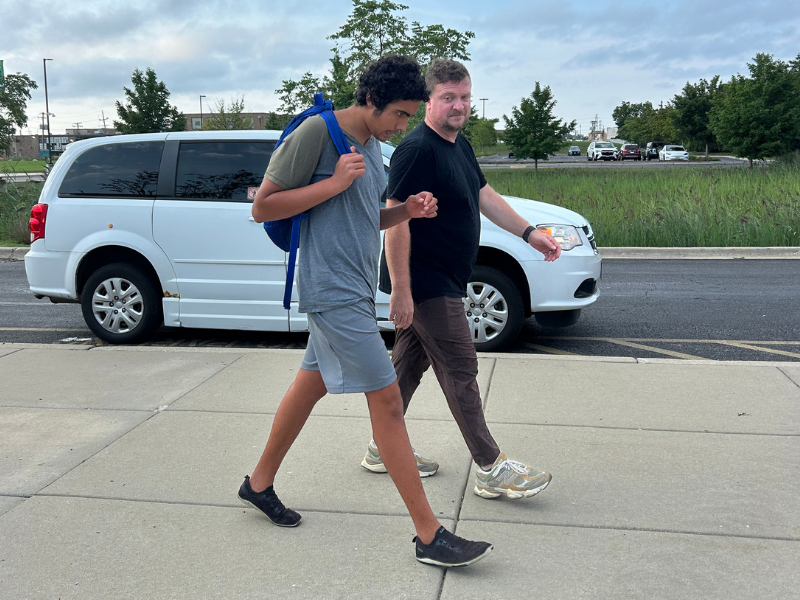 student and staff walking into school on the first day